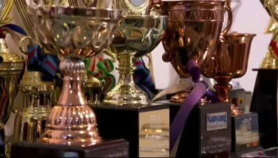 Jina’s cabinet of swimming and triathlon trophies and medals