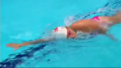 Archive photo of a young Jina swimming freestyle in a training pool